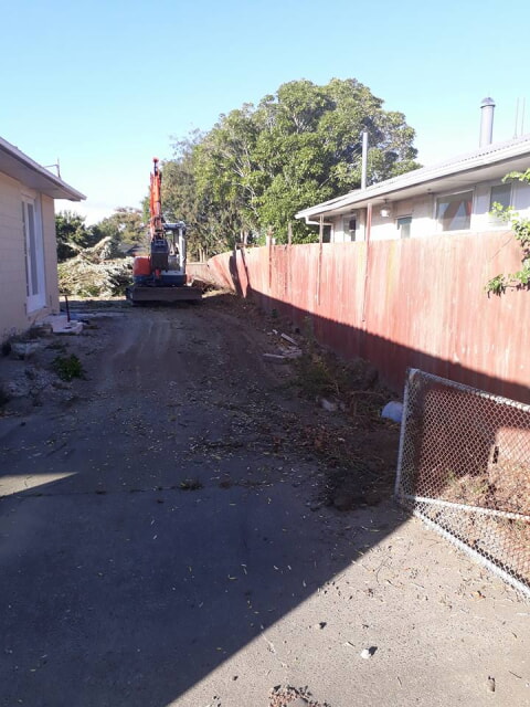 Trees removed and stacked at end of driveway ready to be loaded out